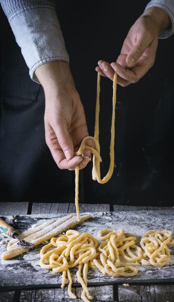 Making pasta by female hands